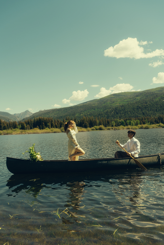 bride and groom ride in the canoe together during their Colorado elopement