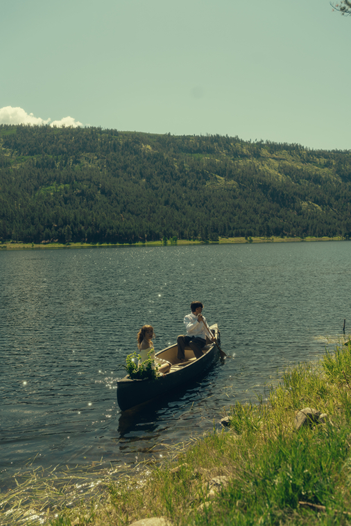 bride and groom ride in the canoe together during their Colorado elopement