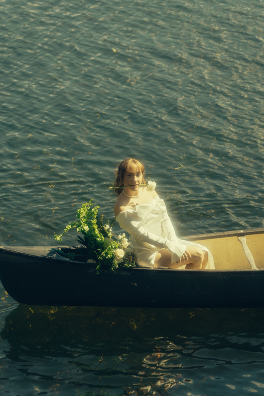 bride and groom ride in the canoe together during their Colorado elopement
