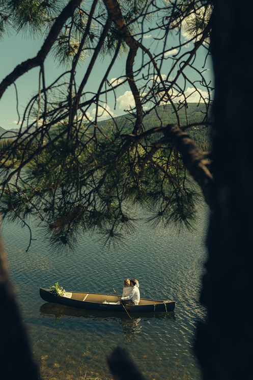 bride and groom ride in the canoe together during their Colorado elopement