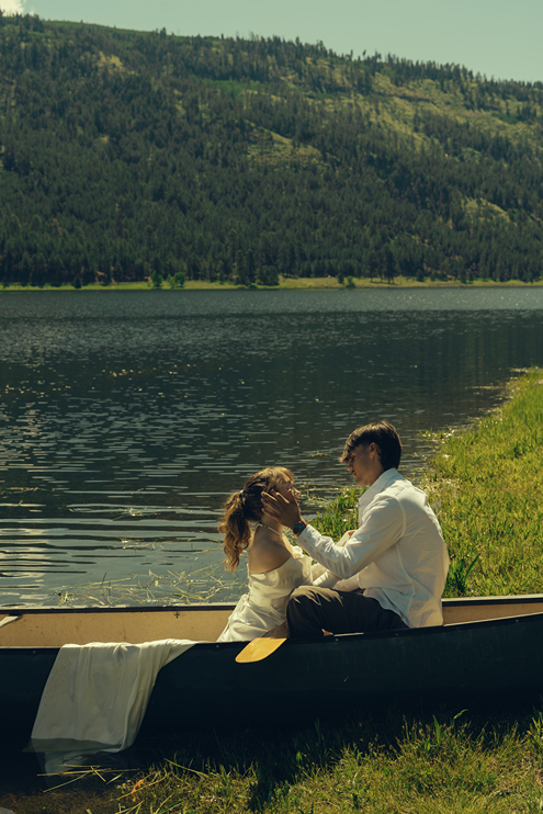 bride and groom share an intimate moment in the canoe before they get out during their durango colorado wedding photos