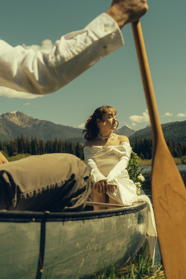 bride basks in the sunlight on the edge of the canoe