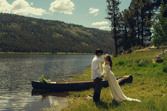 bride leans in for a kiss with the lake glistening in the background of their durango colorado wedding photos