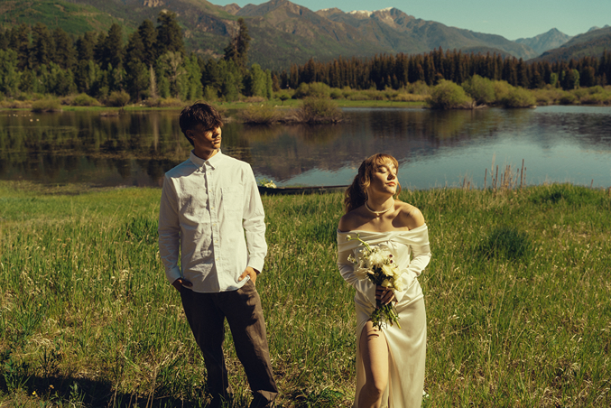 couple pose on the edge of the rocky mountain lake during their Durango Colorado wedding