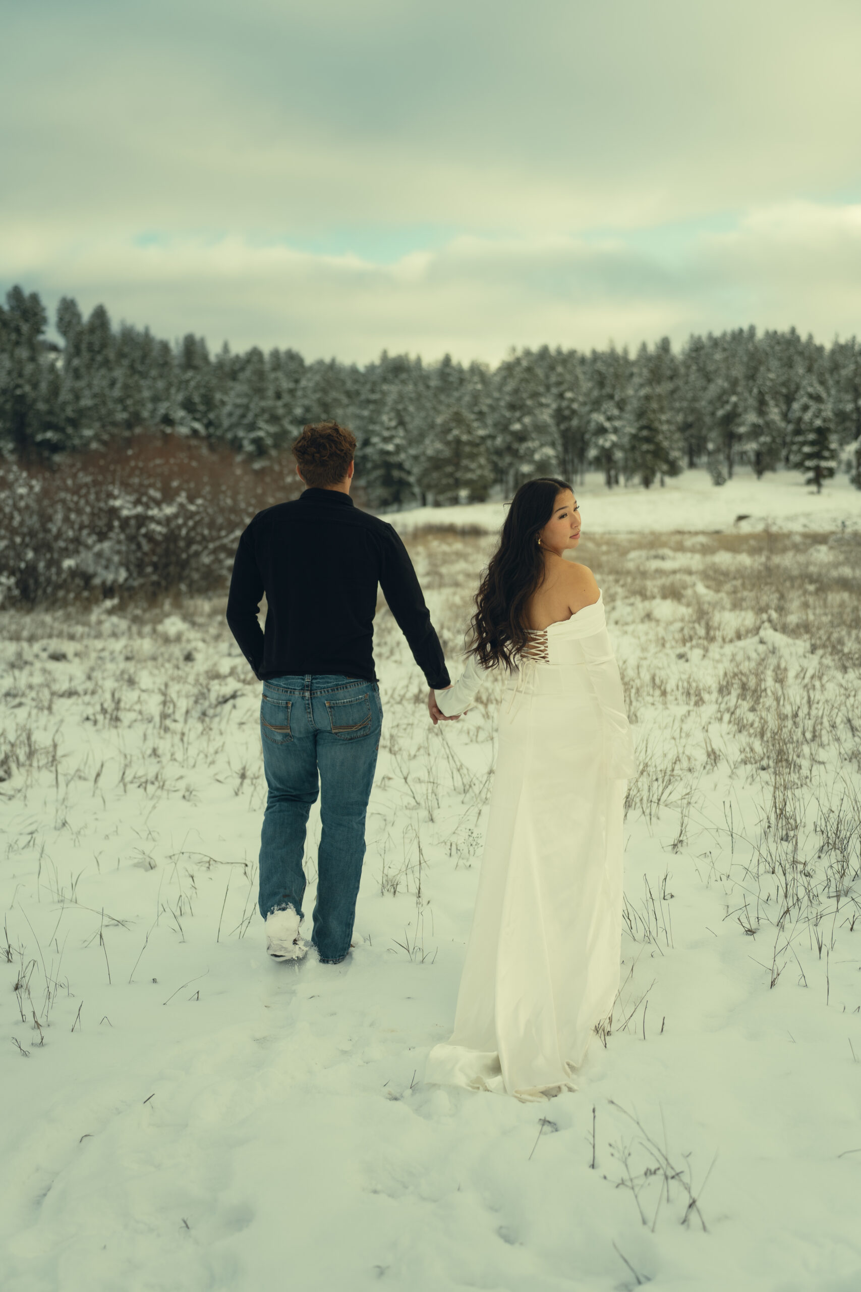 stunning couple pose in the winter snow one of the top reasons to elope in Colorado