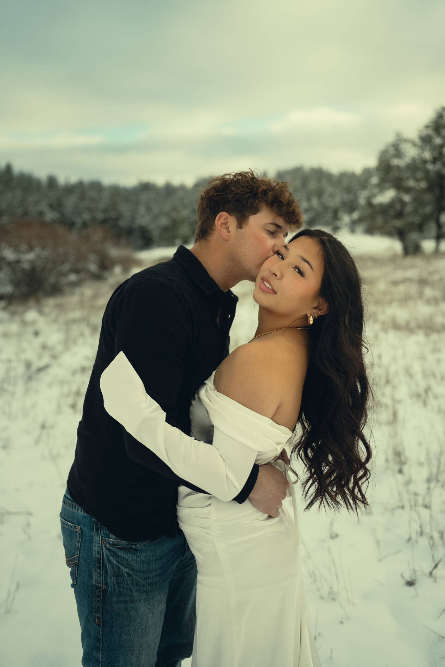 stunning couple pose in the winter snow one of the top reasons to elope in Colorado