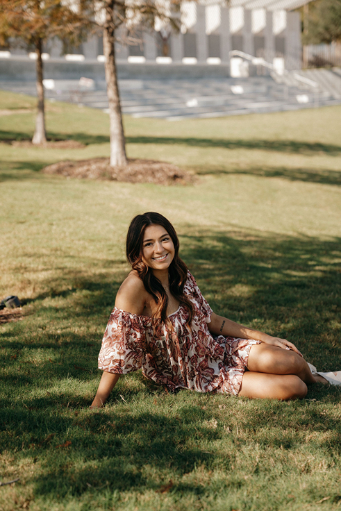 girl poses on campus during her photos