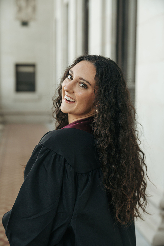 senior poses in her black gown during her Texas A&M senior photography session