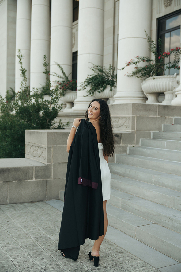 senior poses with her gown during her on campus photoshoot