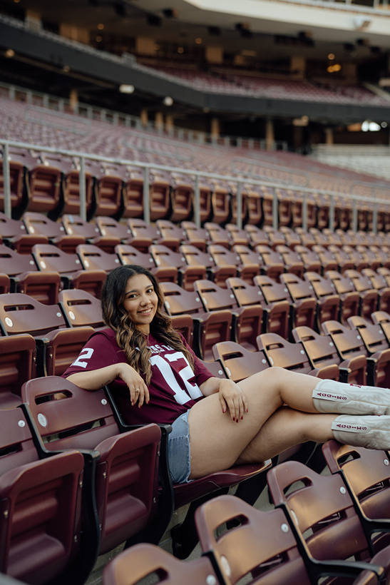 girl poses in Kyle field during her Texas A&M Senior Photo session captured by Sasha Takes Pictures a Texas senior photographer 