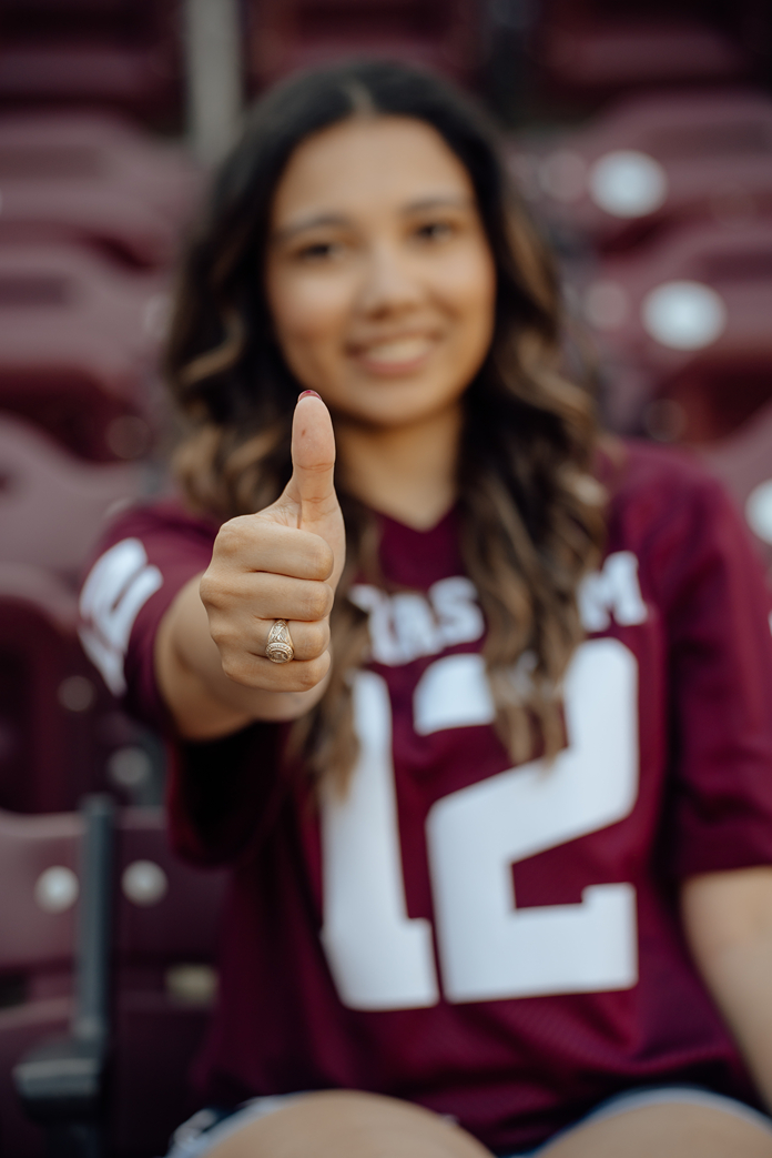 girl poses in her 12th man jersey in Kyle Field during her Texas A&M senior photo session