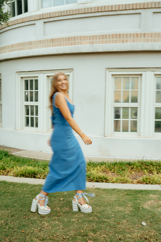 senior walks by during her texas a&m graduation photoshoot with Sasha