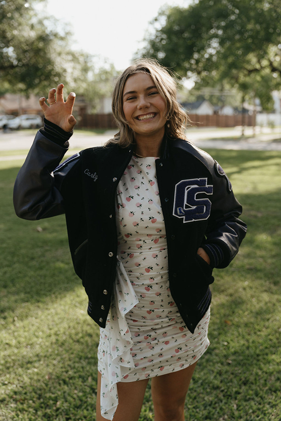 senior poses for a photo while on campus
