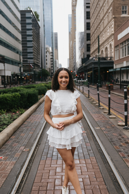 houston area senior poses in town during her Houston senior photoshoot
