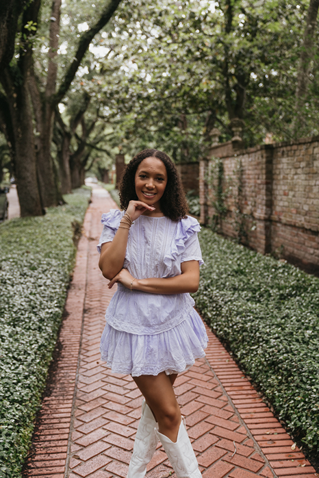 houston area senior poses in town during her Houston senior photoshoot