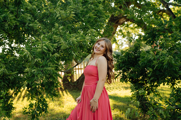 senior poses during her photoshoot with Sasha