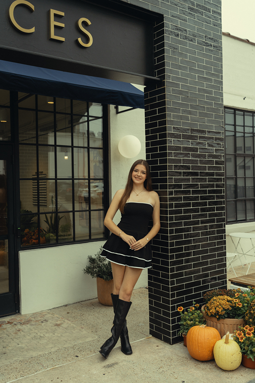 houston area senior poses in town during her Houston senior photoshoot