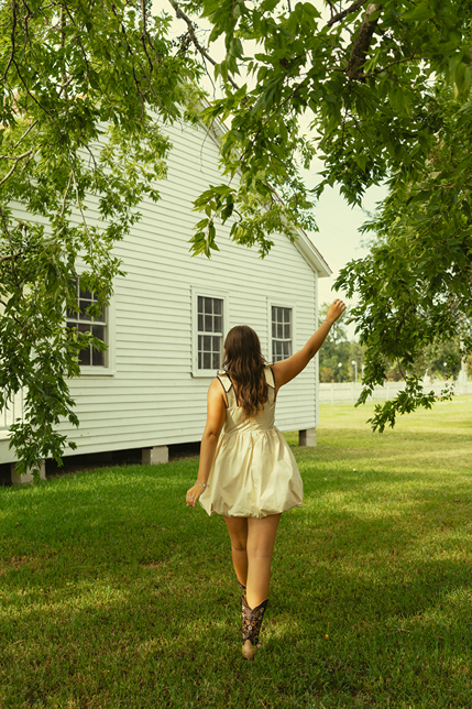 senior poses during her photoshoot with Sasha