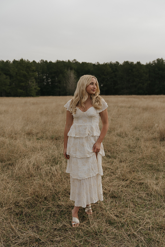 houston senior poses in a Texas field during her photoshoot with Sasha