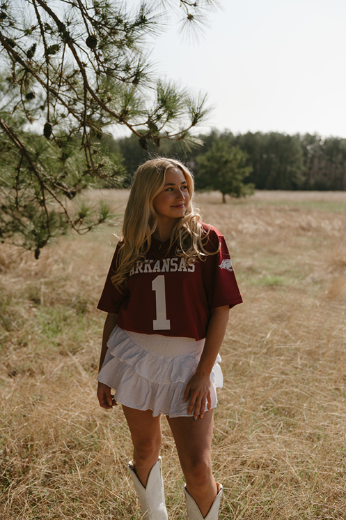 houston senior poses in a Texas field during her photoshoot with Sasha