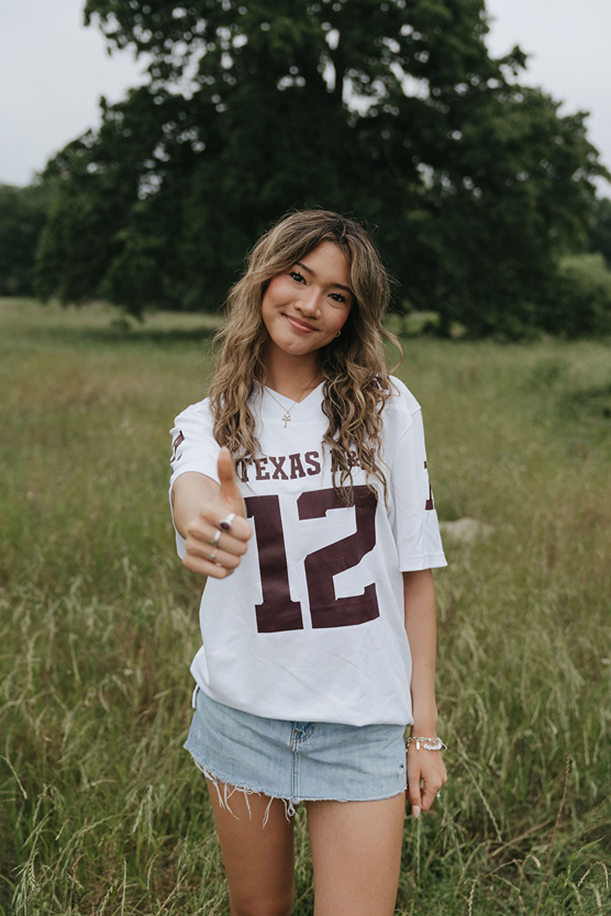 Texas A&M senior gives a thumbs up during her senior photo session