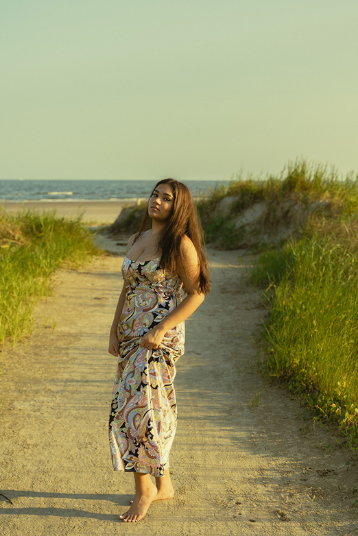 senior poses on the Texas beach during her galveston senior pictures