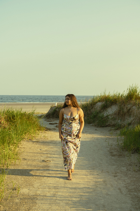 senior walks the path back from the stunning Texas beach