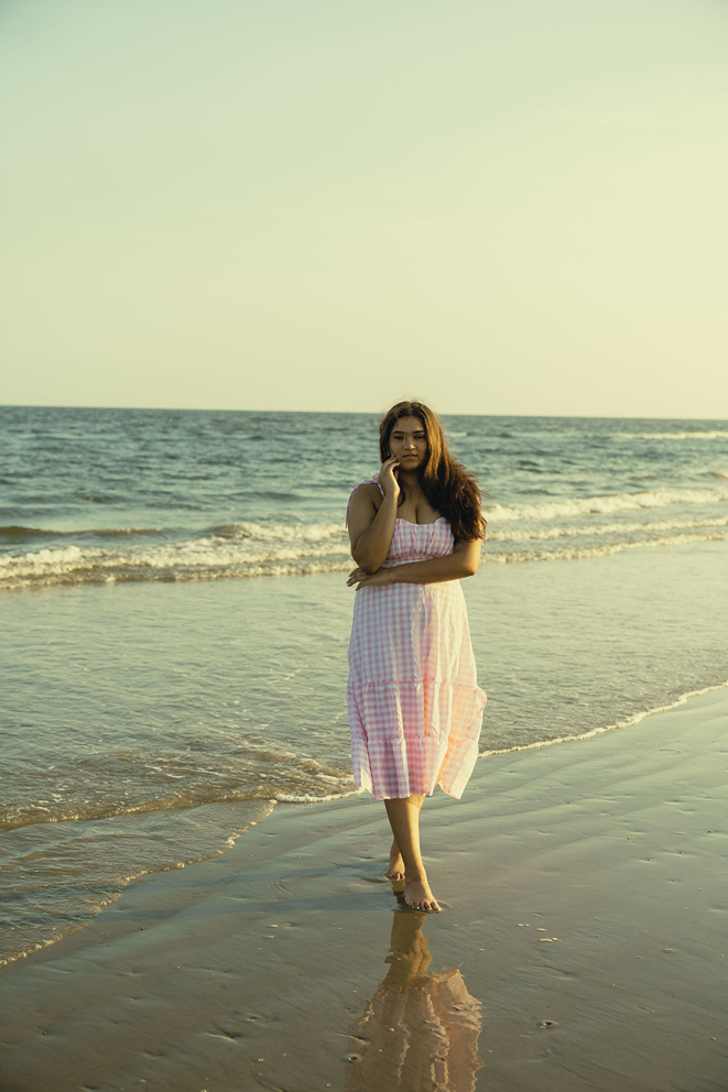 senior poses on the Texas beach during her galveston senior pictures
