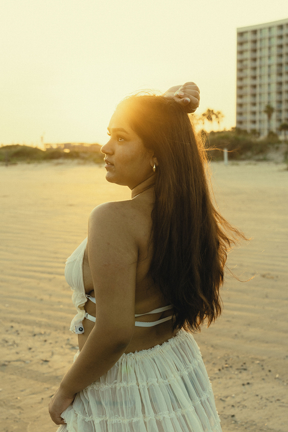 senior poses on the Texas beach during her galveston senior pictures