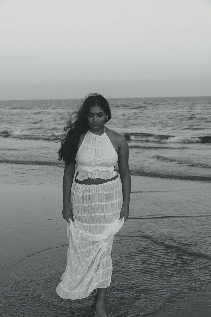senior poses on the Texas beach during her galveston senior pictures