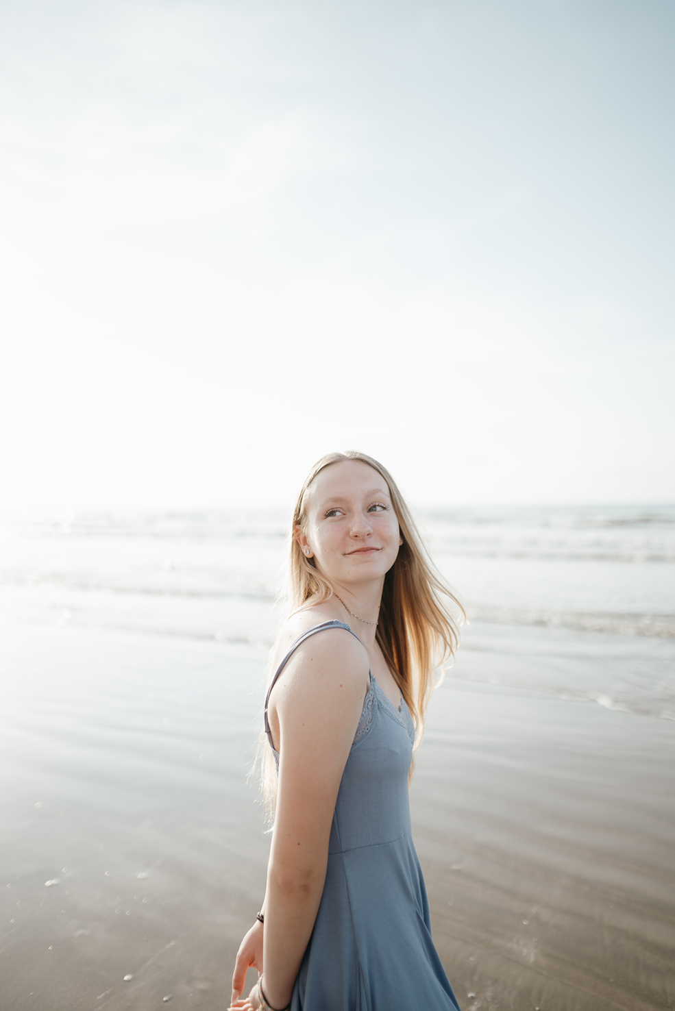 senior poses on the Texas beach during her galveston senior pictures