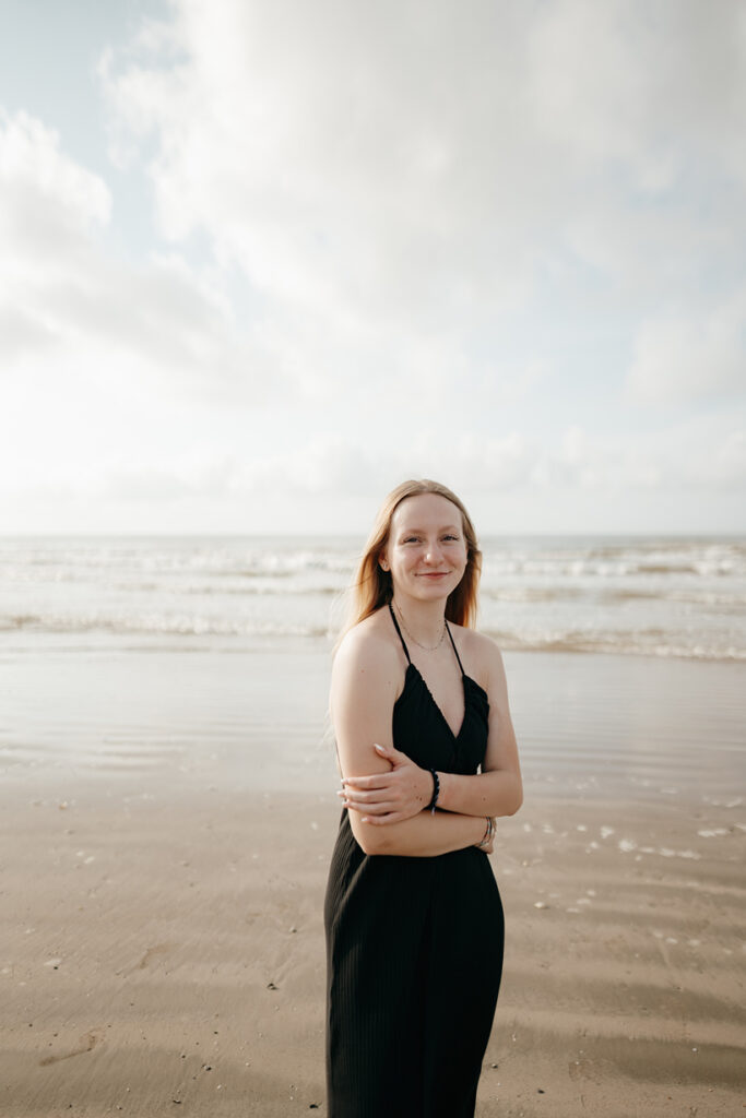senior poses on the Texas beach during her galveston senior pictures