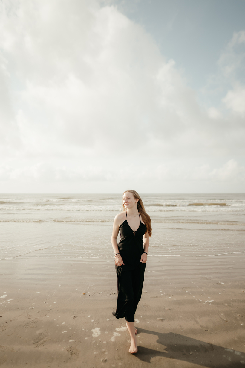 senior poses on the Texas beach during her galveston senior pictures