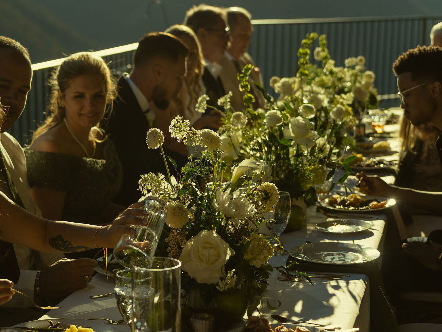 guests celebrate the bride and groom as they eat dinner and celebrate